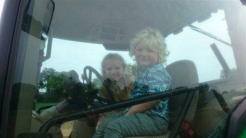 Children behind the wheel of a tractor